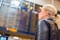 Female traveller checking flight departures board. Royalty Free Stock Photo