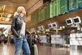 Female traveller checking flight departures board. Royalty Free Stock Photo