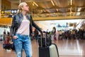 Female traveller checking flight departures board. Royalty Free Stock Photo