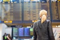 Female traveller checking flight departures board. Royalty Free Stock Photo