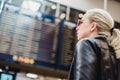 Female traveller checking flight departures board. Royalty Free Stock Photo