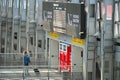 Female traveller holding trolley look at the train schedule at the station