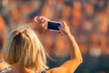 Female traveller make a photo of Dubrovnik to the phone.