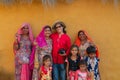 Female traveller and woman photographer posing with smiling and happy Rajasthani women and children in a Rajasthani village