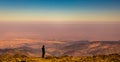 Female trekker enjoys the view from the summit of Jbel Toubkal, Atlas Mountains, Morocco.