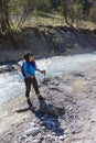 Female trekker standing on the edge of the river