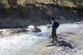 Female trekker standing on the edge of the river