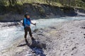 Female trekker standing on the edge of the river