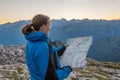 Female trekker studying a map.