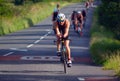 Female Triathlete on road cycling stage of triathlon.