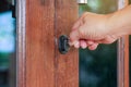 The female turns the key in the lock on the outside door open,putting key into front door Royalty Free Stock Photo