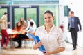 Female Tutor Sitting In Classroom With Folder Royalty Free Stock Photo