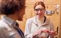 Female Tutor With Trainee Electrician In Workshop Studying For Apprenticeship At College Royalty Free Stock Photo