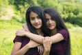 Female twins embrace each other