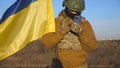 Female ukrainian army soldier using smartphone to read news or messaging with family. Girl in military uniform and