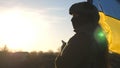 Female ukrainian army soldier using smartphone to read news or messaging with family. Girl in military uniform and