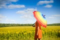 Female under umbrella standing in field of Royalty Free Stock Photo