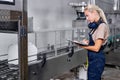 female in uniform checking and counting the quantity and quality of canisters Royalty Free Stock Photo