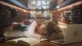 Female in university campus space. Young woman college student sitting in public library, studying for exams, writing Royalty Free Stock Photo
