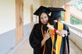 Female university graduates celebrate happily after completed and received diploma degree certificate in commencement ceremony. Th Royalty Free Stock Photo