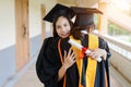 Female university graduates celebrate happily after completed and received diploma degree certificate in commencement ceremony. Th Royalty Free Stock Photo