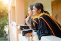 Female university graduates celebrate happily after completed and received diploma degree certificate in commencement ceremony. Th Royalty Free Stock Photo