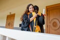 Female university graduates celebrate happily after completed and received diploma degree certificate in commencement ceremony. Th Royalty Free Stock Photo