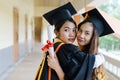 Female university graduates celebrate happily after completed and received diploma degree certificate in commencement ceremony. Th Royalty Free Stock Photo