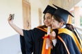 Female university graduates celebrate happily after completed and received diploma degree certificate in commencement ceremony. Th Royalty Free Stock Photo