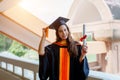 Female university graduates celebrate happily after completed and received diploma degree certificate in commencement ceremony. Th Royalty Free Stock Photo