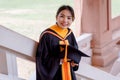 Female university graduates celebrate happily after completed and received diploma degree certificate in commencement ceremony. Th Royalty Free Stock Photo