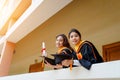 Female university graduates celebrate happily after completed and received diploma degree certificate in commencement ceremony. Th Royalty Free Stock Photo