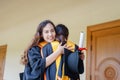 Female university graduates celebrate happily after completed and received diploma degree certificate in commencement ceremony. Th Royalty Free Stock Photo