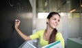 Female university student in front of a blackboard solving a problem Royalty Free Stock Photo