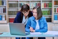 Female university student with teacher preparing for exam, inside library Royalty Free Stock Photo