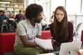 Female University Student Working In Library With Tutor Royalty Free Stock Photo