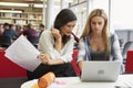 Female University Student Working In Library With Tutor Royalty Free Stock Photo