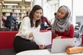 Female University Student Working In Library With Tutor Royalty Free Stock Photo