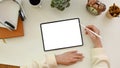 A female using a digital tablet, designing her artwork, working at her minimal white office desk Royalty Free Stock Photo