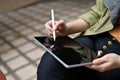 A female using a digital tablet touchpad, using stylus pen to design her graphic artwork Royalty Free Stock Photo