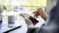 A female using her smartphone while relaxing in the coffee shop in the morning Royalty Free Stock Photo