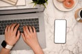 A female using portable laptop computer, typing on keyboard, working at white marble desk Royalty Free Stock Photo