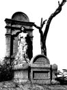 Female vampire leaning against tombstone