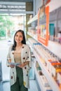 female vape seller standing beside the store shelf