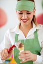 Female vendor in confectionery putting ice cream ball in cone