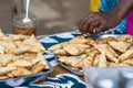 Female vendor selling fried pastry outdoors in the centre of Nosy Be, Madagascar