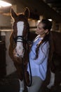 Female vet examining brown horse Royalty Free Stock Photo