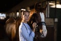 Female vet stroking horse at stable Royalty Free Stock Photo