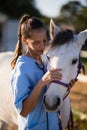 Female vet stroking white horse Royalty Free Stock Photo