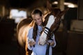 Female vet using mobile phone while standing by horse Royalty Free Stock Photo